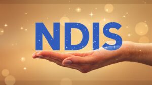 a hand holding the word "NDIS" reflecting its meaning