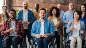 A diverse group of people with visible physical impairments smiling and engaging in various activities (work, sports, art)