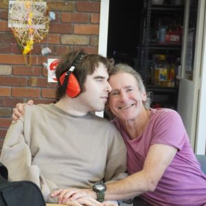 how to work for ndis shows a support worker hugging a participant